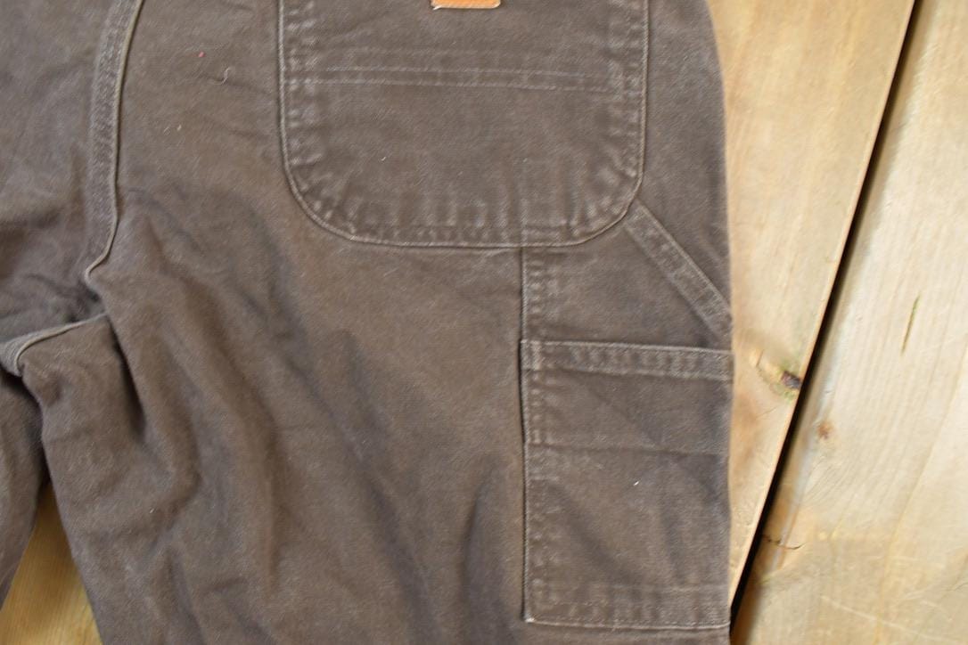 Vintage 1990s Carhartt Brown Denim Work Pants Men's 38 x 30 from propervintagecanada