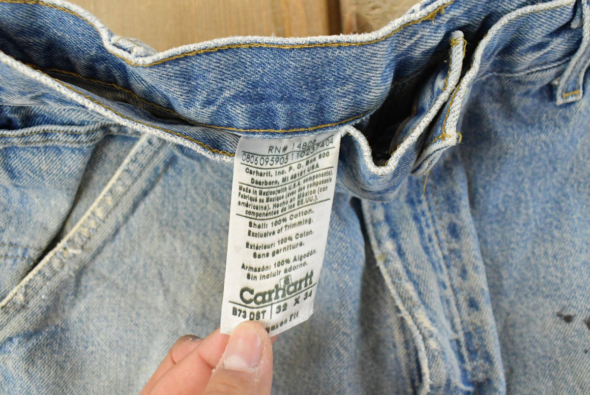 Vintage 1990s Carhartt Distressed Double Knee Denim Work Jeans Men's 31 x 33 from propervintagecanada