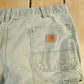 Vintage 1990s Carhartt Distressed Sun Faded Denim Work Jeans Men's 37 x 30 from propervintagecanada