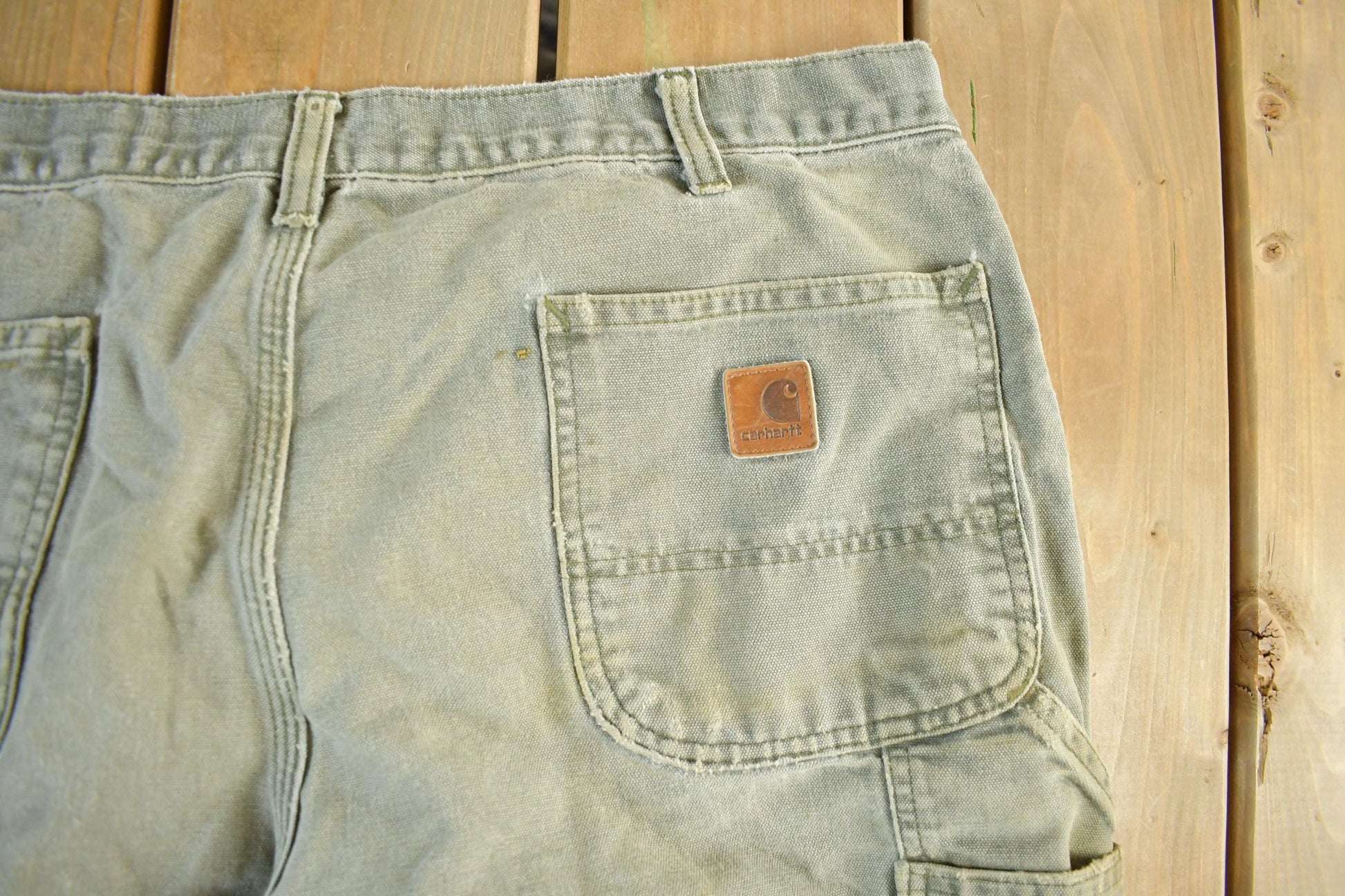 Vintage 1990s Carhartt Distressed Sun Faded Denim Work Jeans Men's 37 x 30 from propervintagecanada