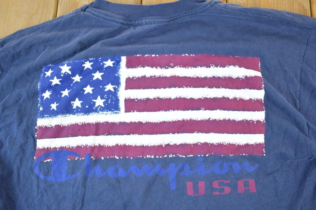 Vintage 1990s Champion American Flag Souvenir Single Stitch Graphic Print T-Shirt Men's XL from propervintagecanada