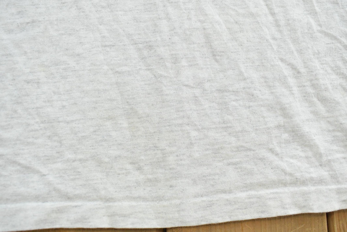 Vintage 1990s Champion Big Logo Spellout Graphic T-Shirt Men's L from propervintagecanada