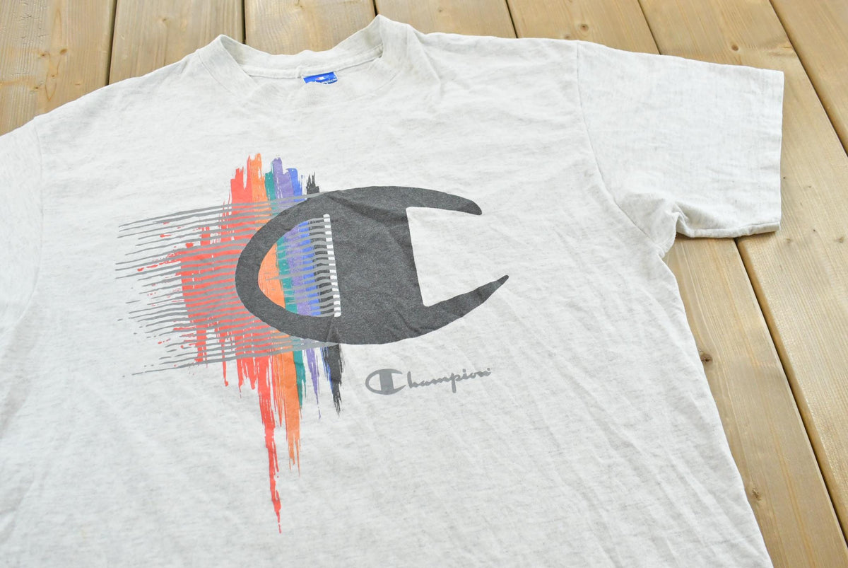 Vintage 1990s Champion Big Logo Spellout Graphic T-Shirt Men's L from propervintagecanada