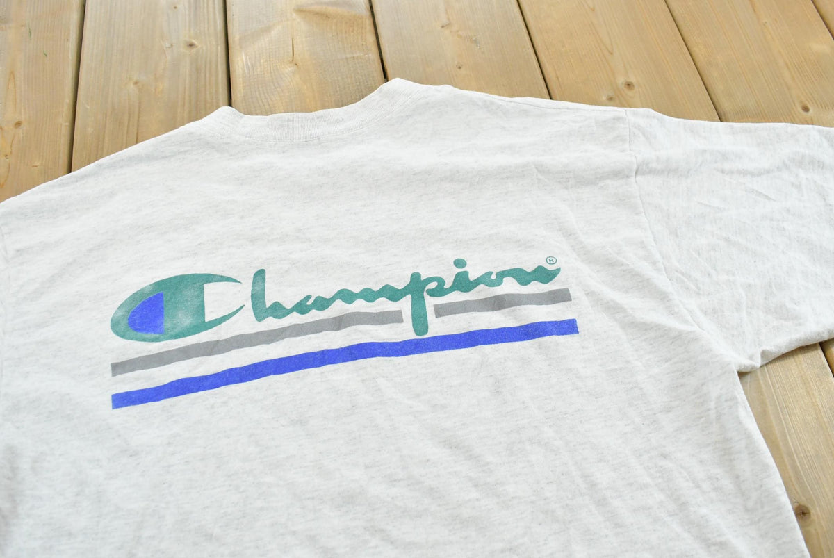 Vintage 1990s Champion Big Logo Spellout Graphic T-Shirt Men's L from propervintagecanada