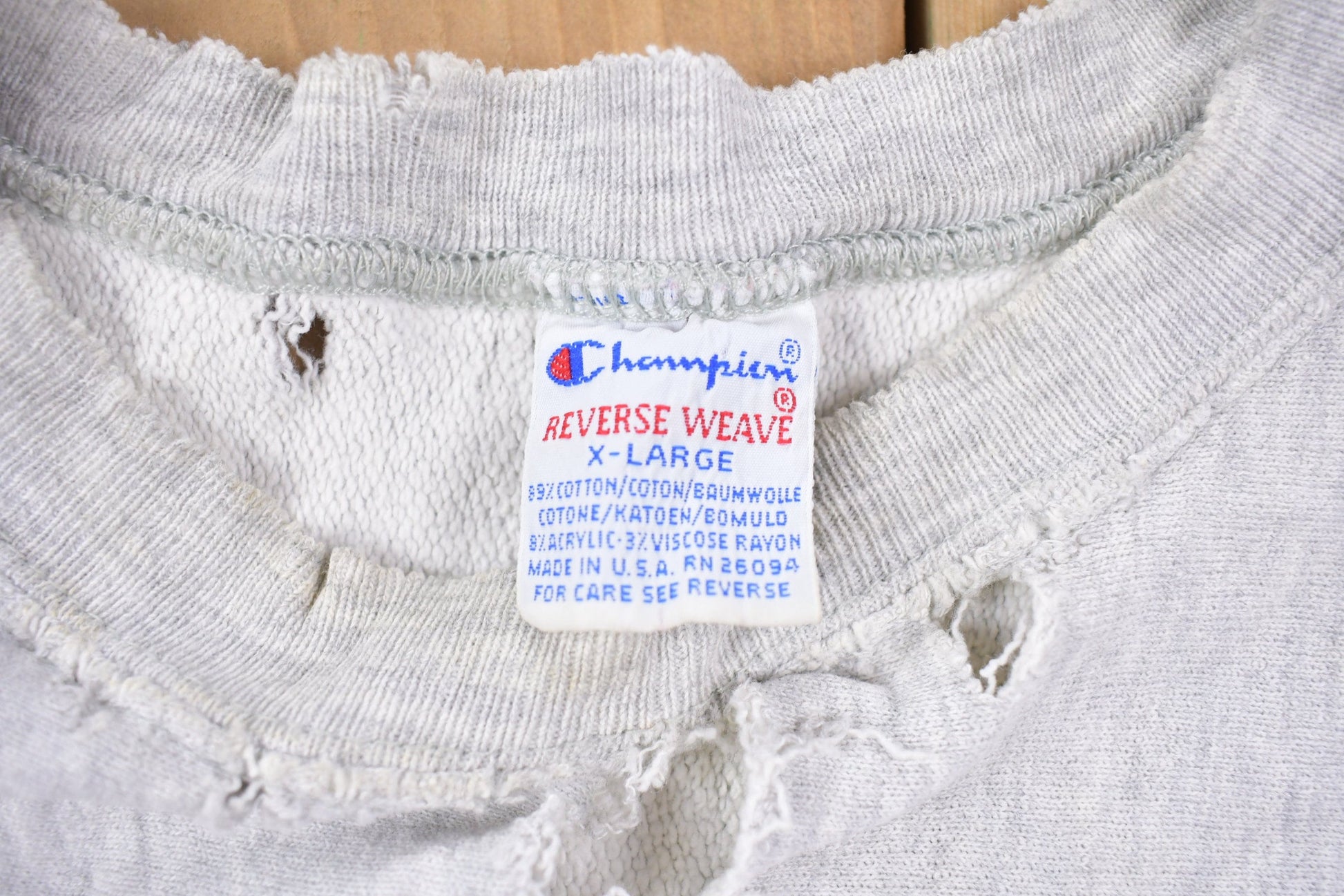 Vintage 1990s Champion Reverse Weave Distressed John Carroll Sweatshirt Men's Large from propervintagecanada
