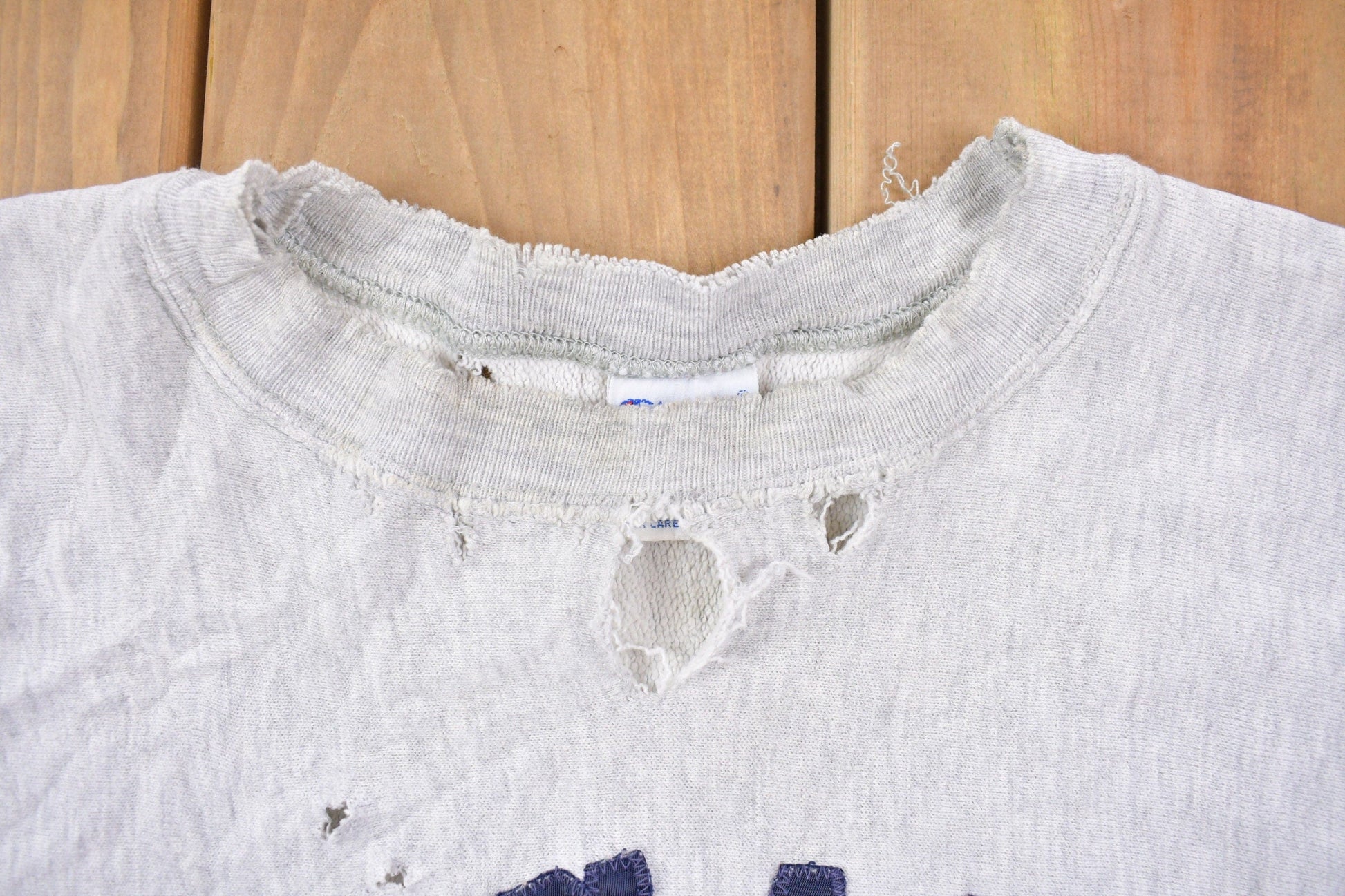 Vintage 1990s Champion Reverse Weave Distressed John Carroll Sweatshirt Men's Large from propervintagecanada