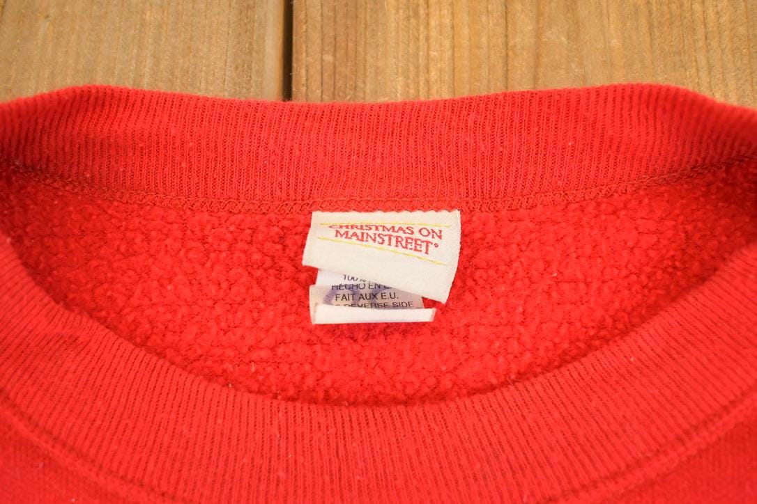 Vintage 1990s Christmas AOP Souvenir Crewneck Sweatshirt Mens L from propervintagecanada