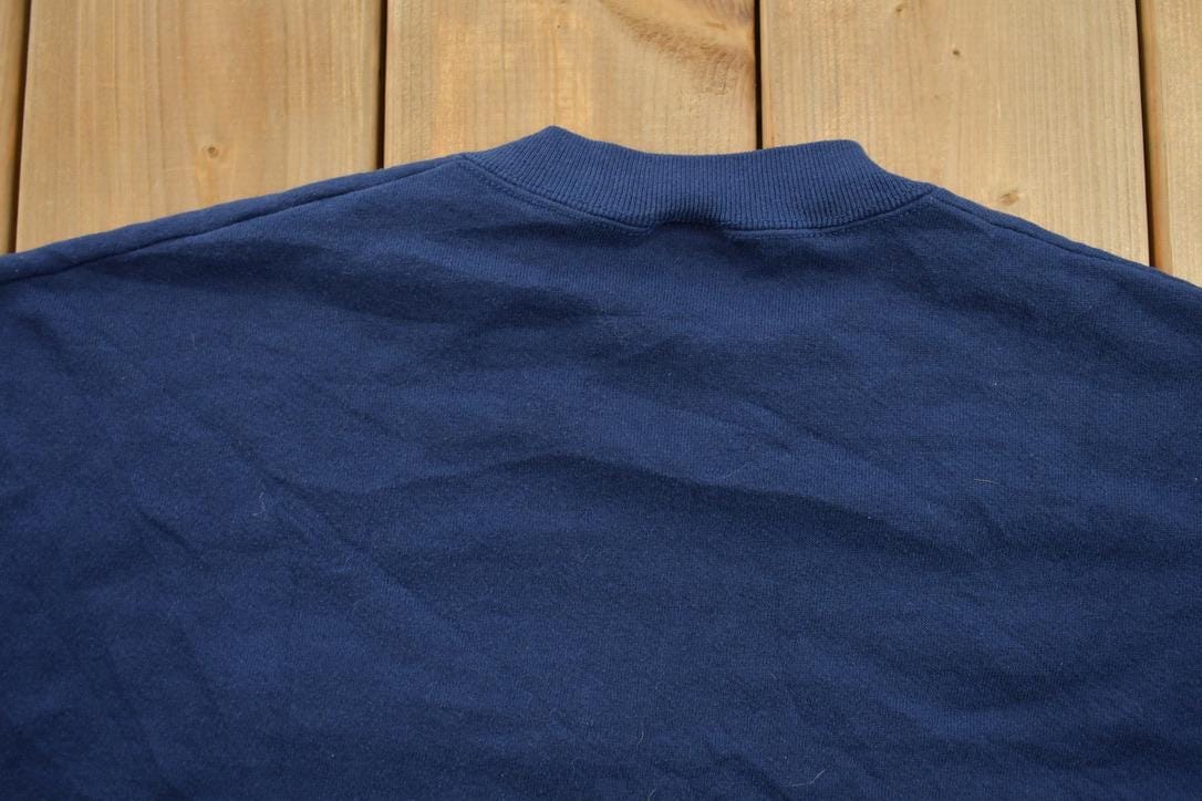 Vintage 1990s College Graphic Collegiate Crewneck Sweatshirt Men's Large from propervintagecanada