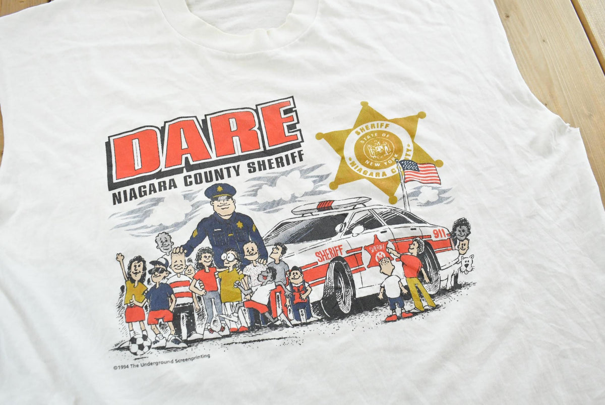 Vintage 1990s Dare to Resist Drugs And Violence Dare Niagara Sheriff Cutoff Tank Top T-Shirt Men's L from propervintagecanada
