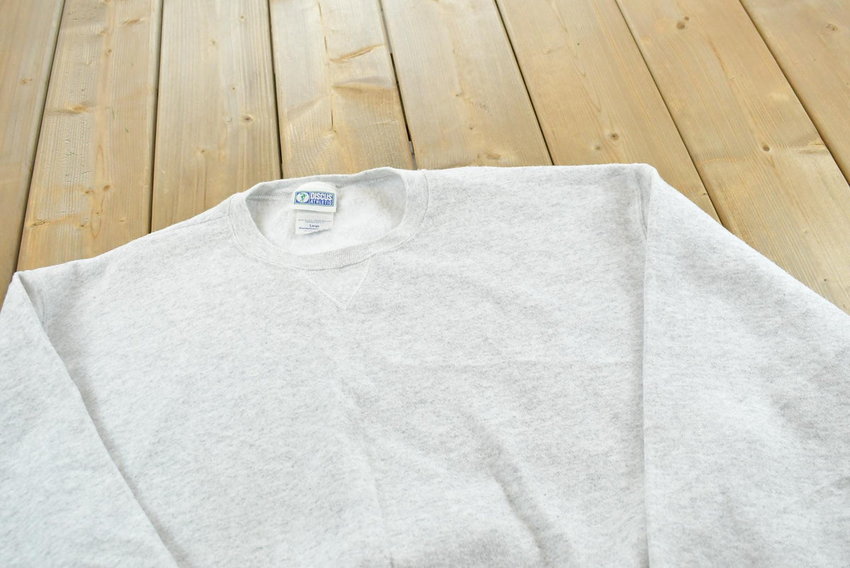 Vintage 1990s Discus Athletics Made In USA Basic Blank Grey Crewneck Sweatshirt Men's L from propervintagecanada