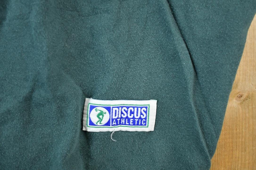 Vintage 1990s Discuss Athletic Souvenir Single Stitch Graphic Print T-Shirt Men's XL from propervintagecanada