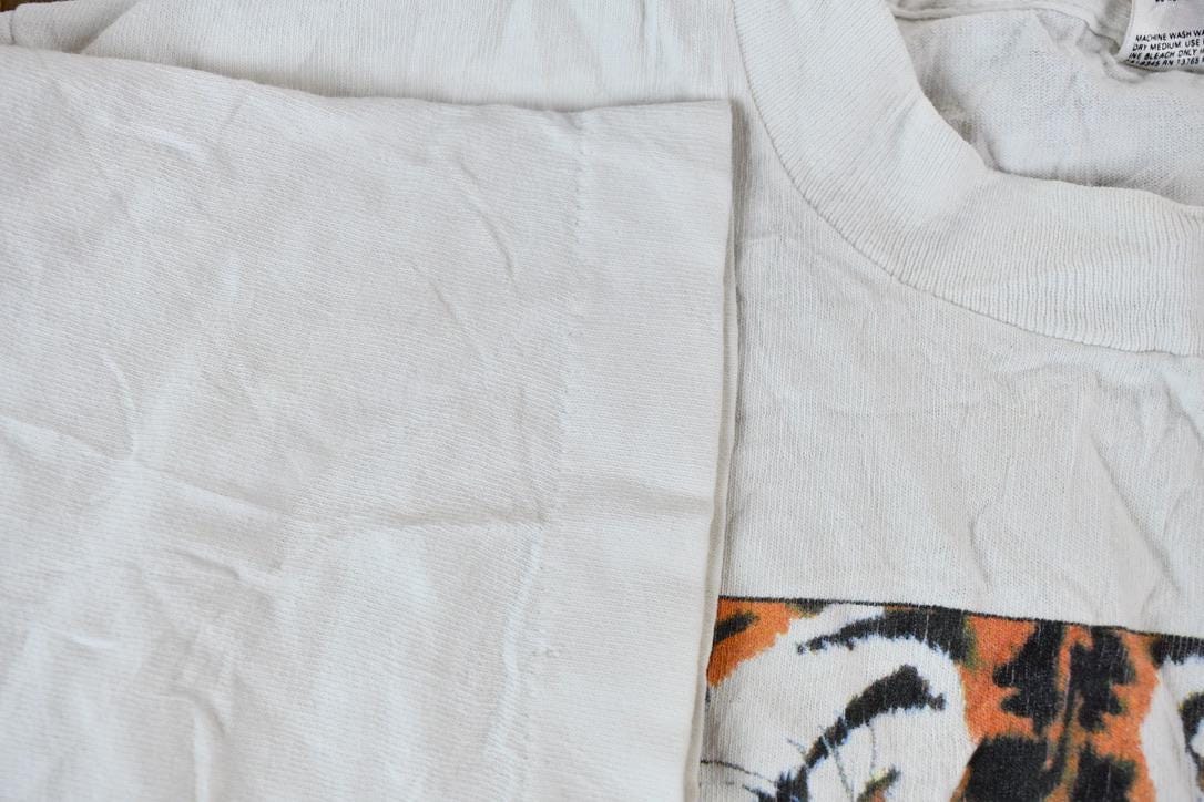 Vintage 1990s Eyes on Survival Realistic Tiger Theme Single Stitch Graphic T-Shirt Men's XS from propervintagecanada