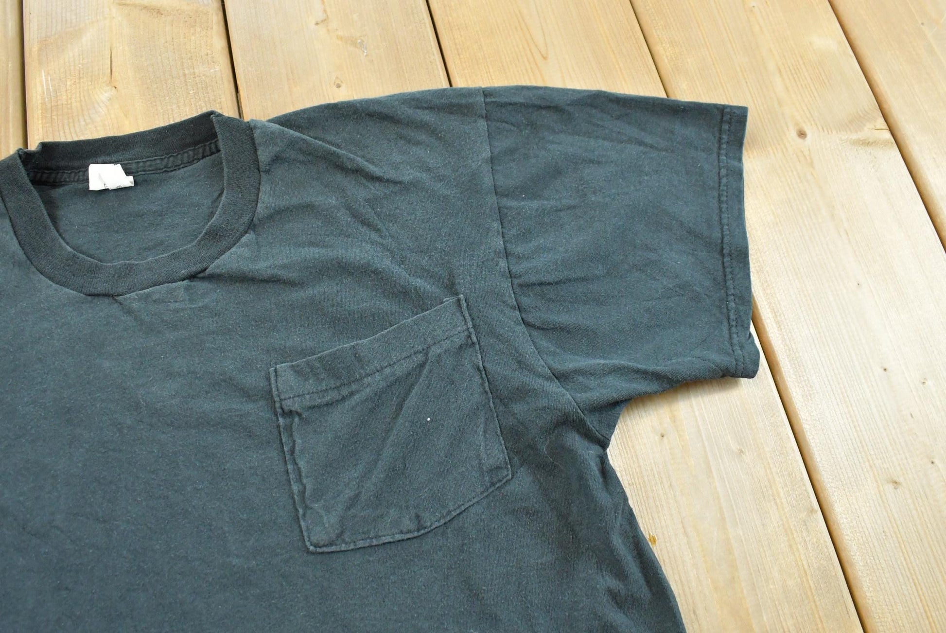 Vintage 1990s Fruit of the Loom Black Blank Pocket T-Shirt Men's M from propervintagecanada