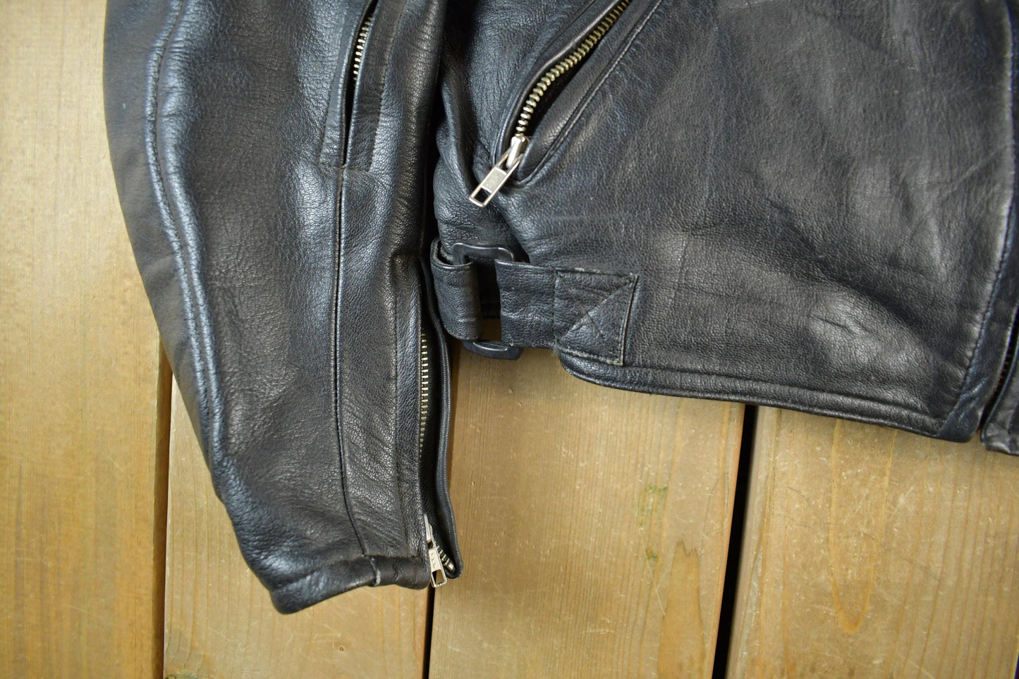Vintage 1990s Genuine Leather Biker Jacket Padded Sleeve Adult Large Men's Medium from propervintagecanada