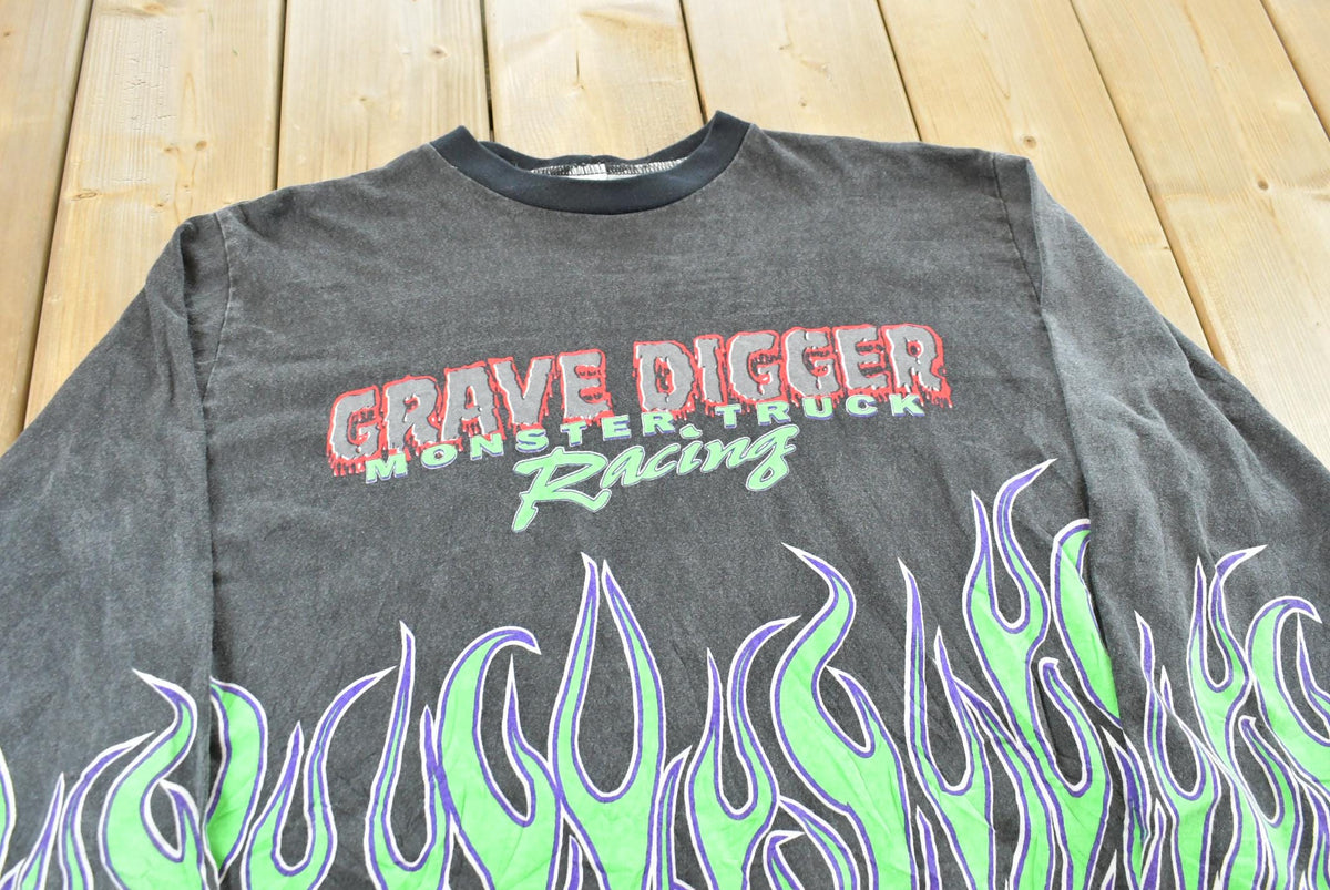 Vintage 1990s Grave Digger Flame AOP Monster Truck Graphic Long Sleeve T-Shirt Men's XL from propervintagecanada