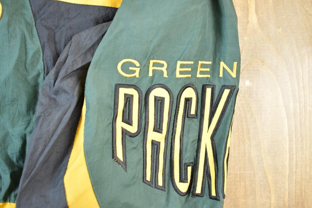 Vintage 1990s Green Bay Packers AOP Proline Logo Athletic NFL Football Warm Up Spring Jacket Men's Large from propervintagecanada