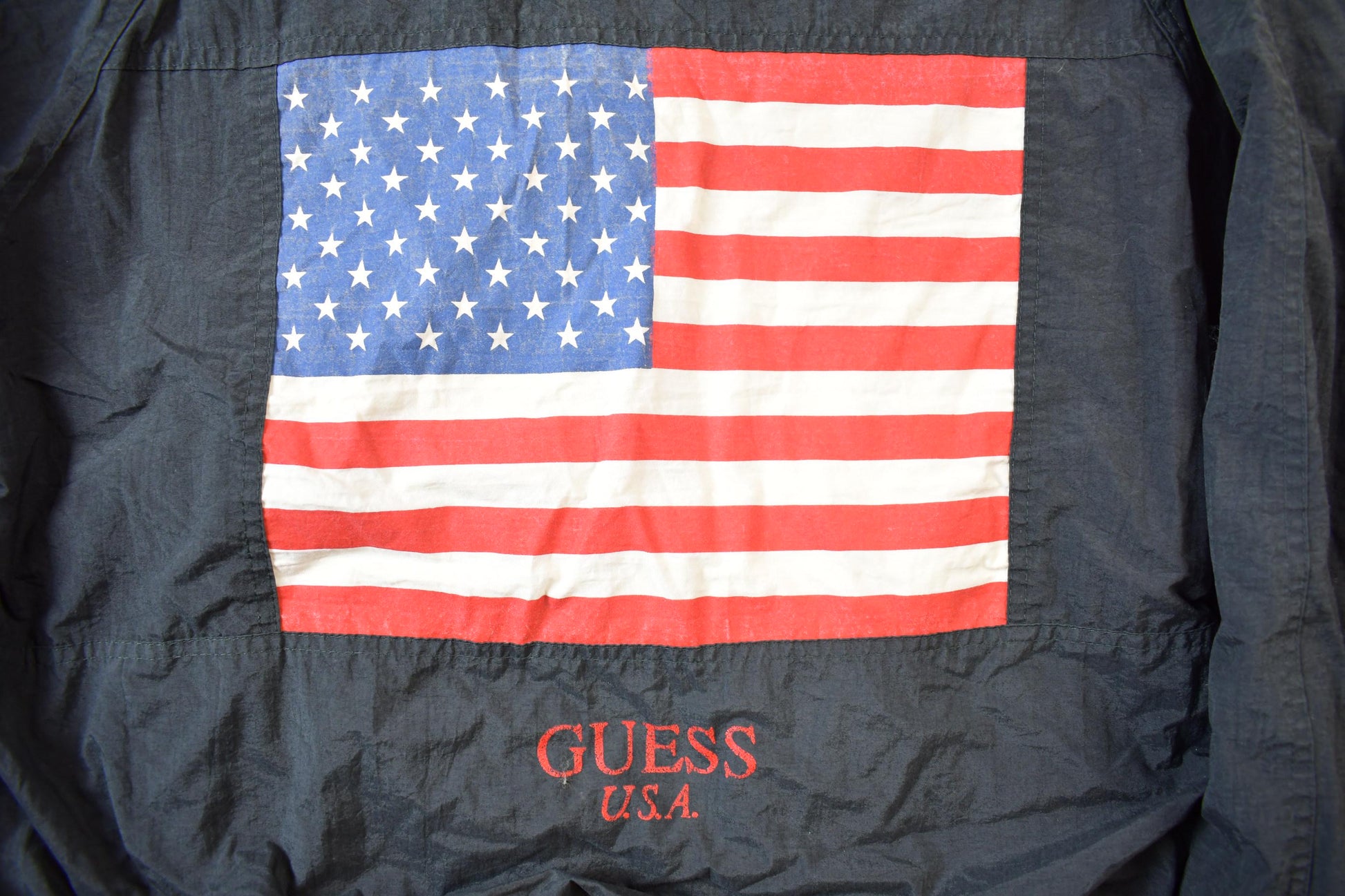 Vintage 1990s Guess USA American Flag Back Logo Bomber Jacket from propervintagecanada