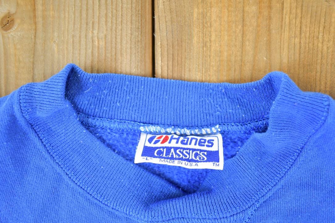 Vintage 1990s Hanes Souvenir Crewneck Sweatshirt Made In USA Men's Large from propervintagecanada