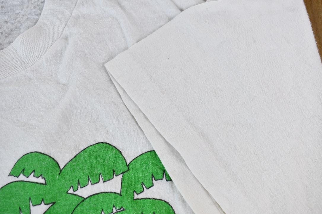 Vintage 1990s Hot Tub Club Tropical Penguins Single Stitch Graphic T-Shirt Men's Small from propervintagecanada