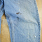 Vintage 1990s Levi's Paint Distressed Orange Tab Denim Jeans Men's 34 x 34 from propervintagecanada