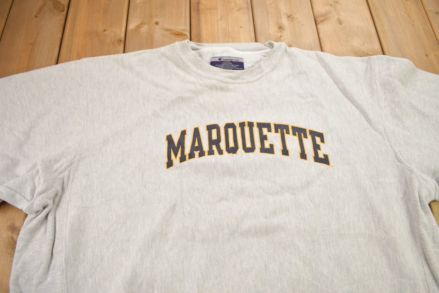 Vintage 1990s Marquette University Champion Reverse Weave Crewneck Sweatshirt Men's 2XL from propervintagecanada