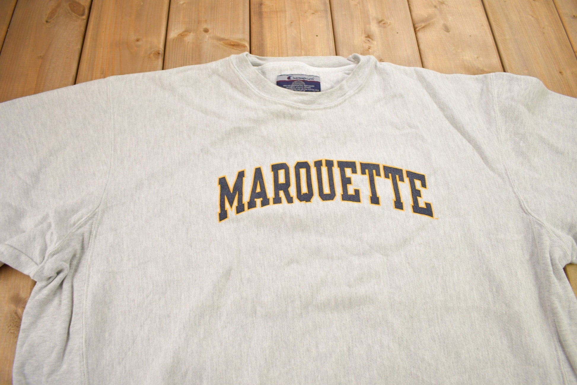 Vintage 1990s Marquette University Champion Reverse Weave Crewneck Sweatshirt Men's 2XL from propervintagecanada