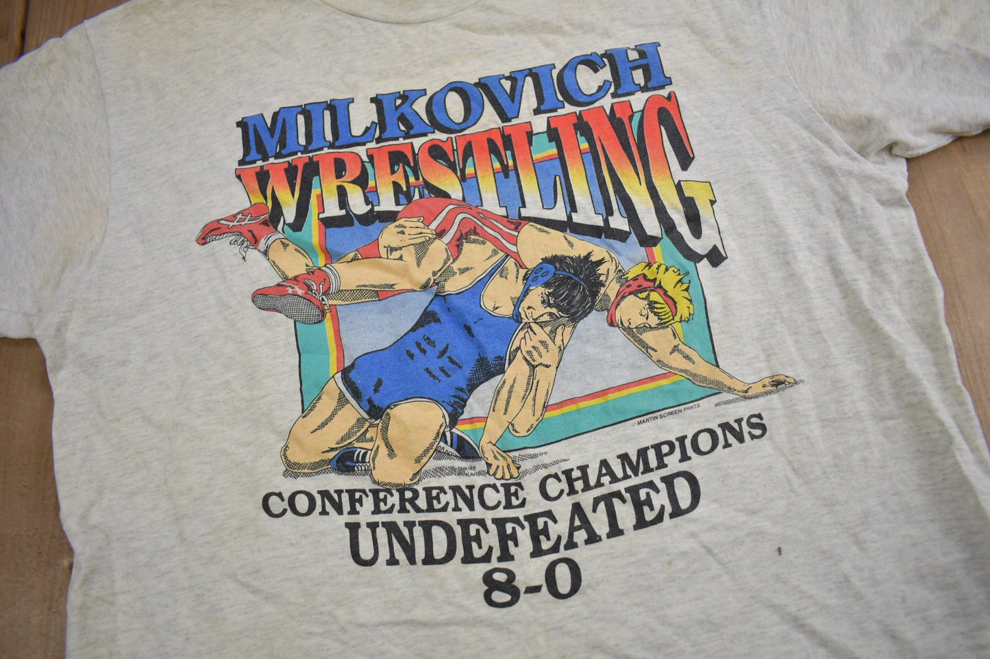 Vintage 1990s Milkovich Wrestling Conference Champions Graphic T Shirt Men's XL from propervintagecanada