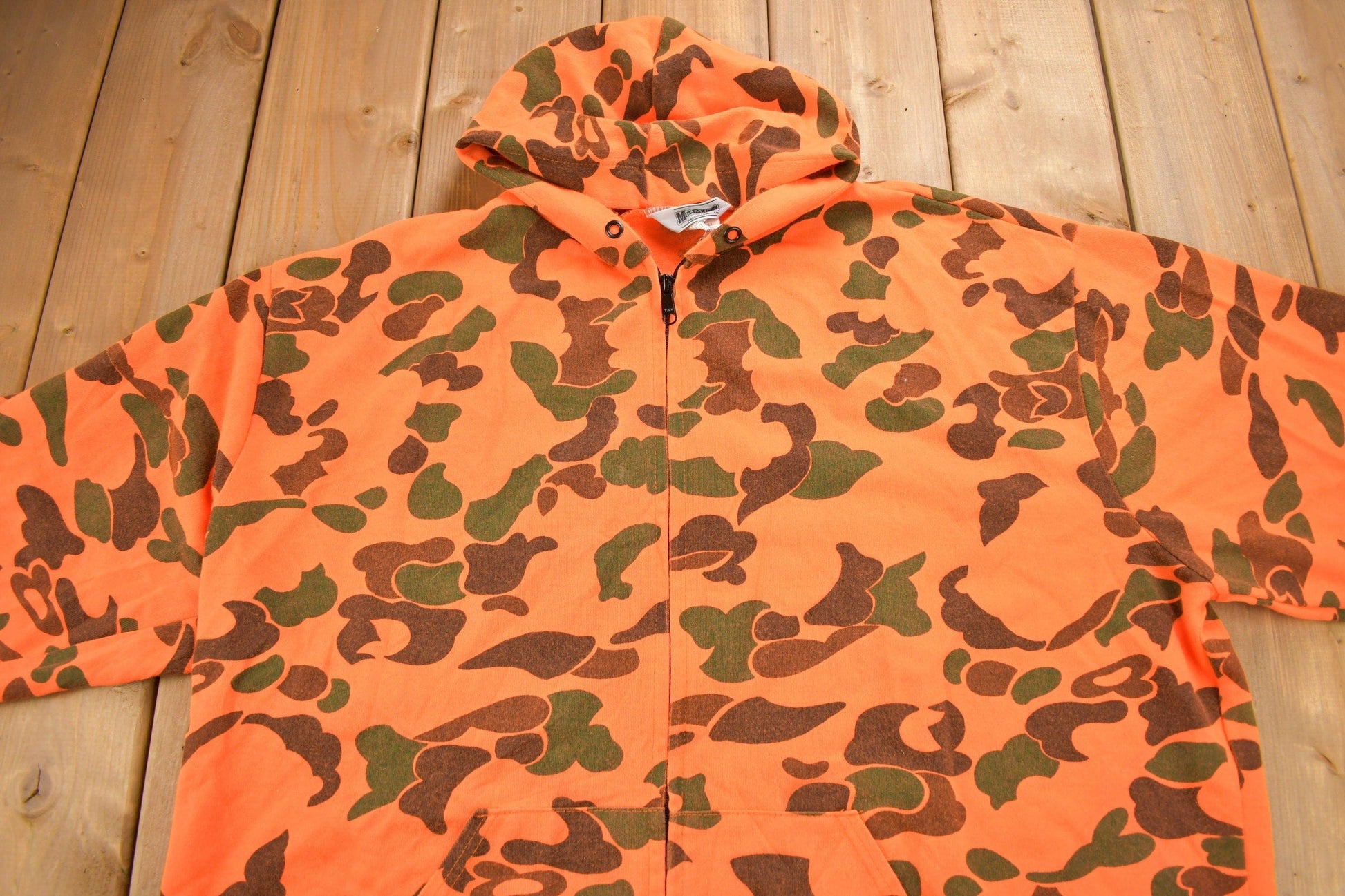 Vintage 1990s Moleskins Orange Camo Graphic Hoodie Men's 2XL from propervintagecanada