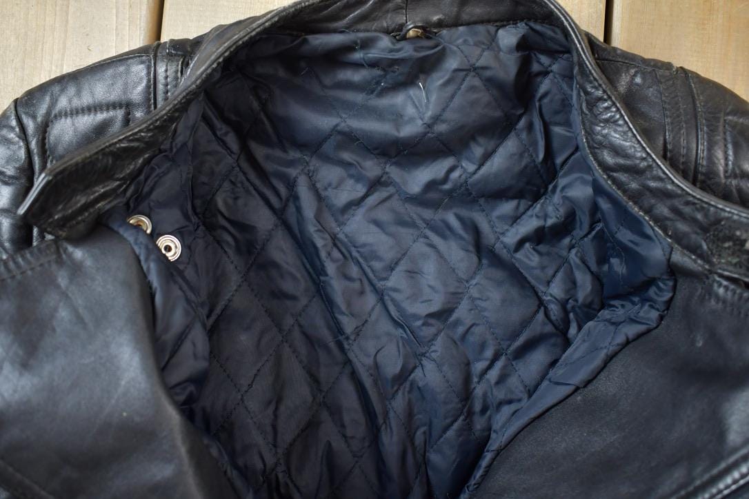 Vintage 1990s Motorcycle Leather Heavy Padded Biker Jacket Made In USA from propervintagecanada
