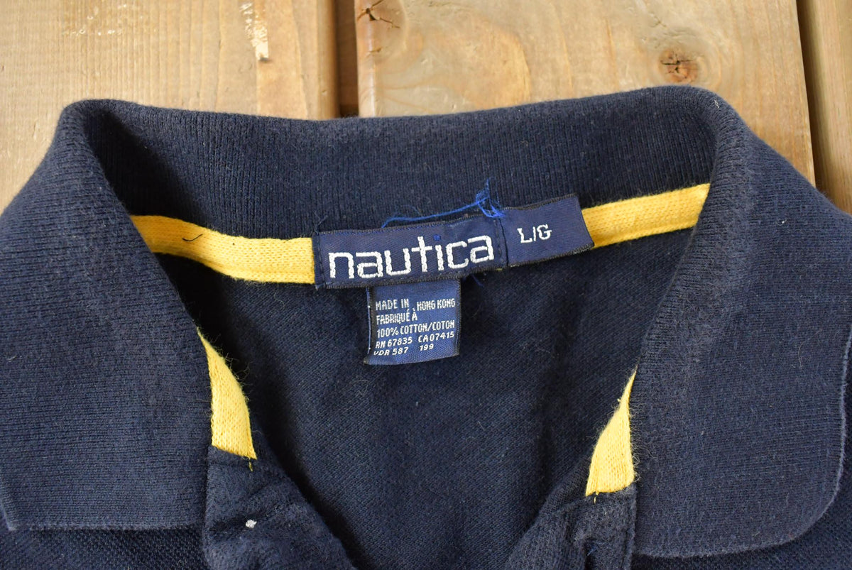 Vintage 1990s Nautica Striped Polo Shirt Men's Large from propervintagecanada
