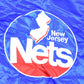 Vintage 1990s New Jersey Nets Hardwood Classics Satin Button Down Puffer Bomber Style NBA Basketball Jacket from propervintagecanada