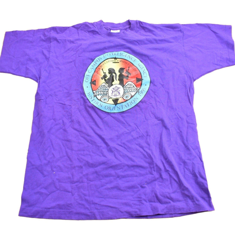 Vintage 1990s Off Campus International Agency Western Orientation Graphic T Shirt Men's XL from propervintagecanada