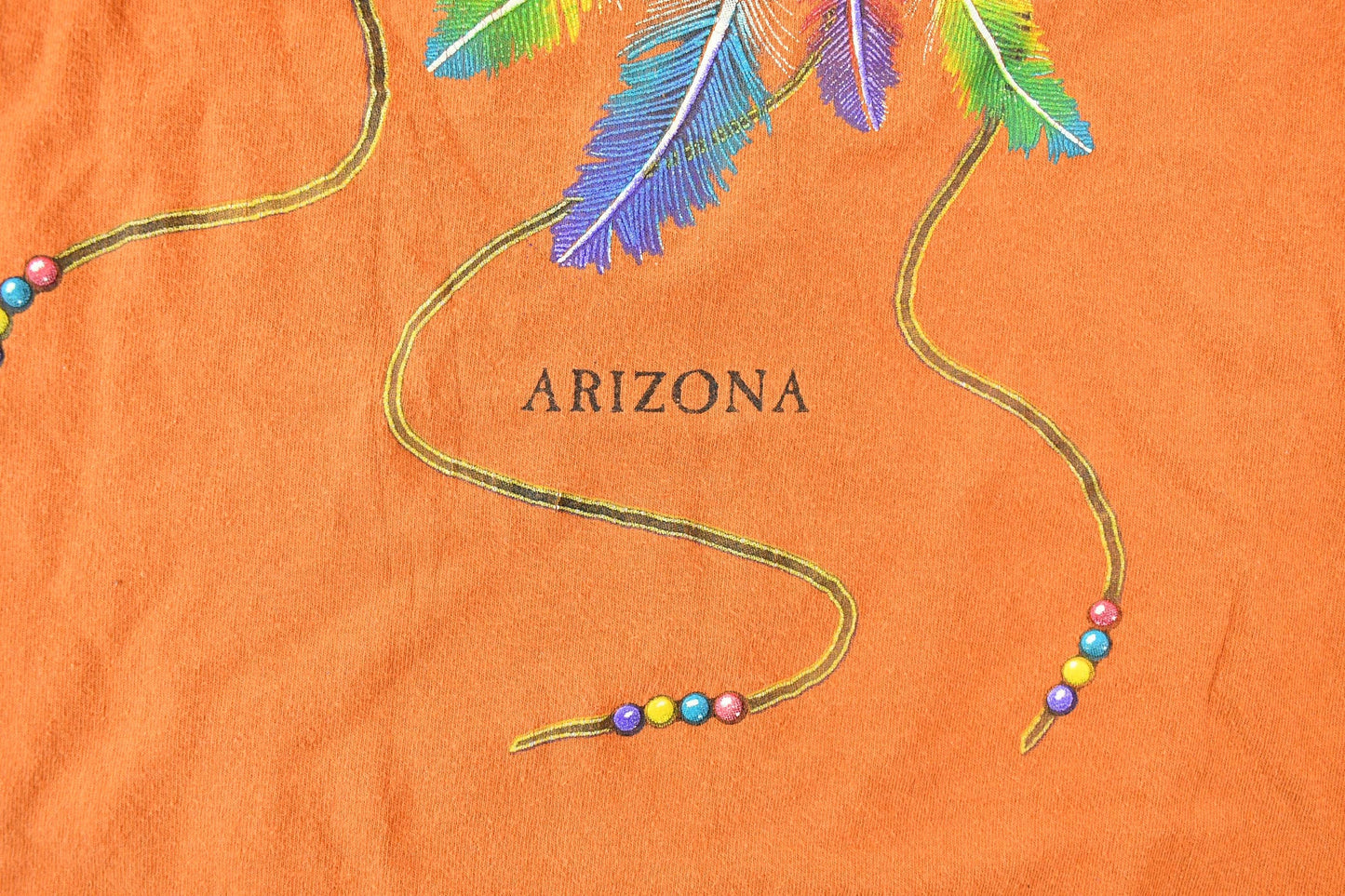 Vintage 1990s Orange Souvenir Arizona USA Feather and Bead Horse Travel T-Shirt Men's Small from propervintagecanada