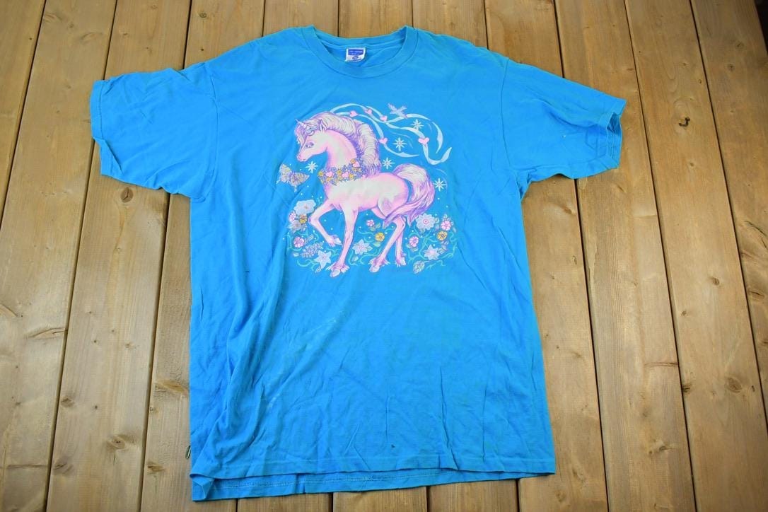 Vintage 1990s Pink Pony Unicorn Club Souvenir Single Stitch Graphic Print T-Shirt Men's 2XL from propervintagecanada