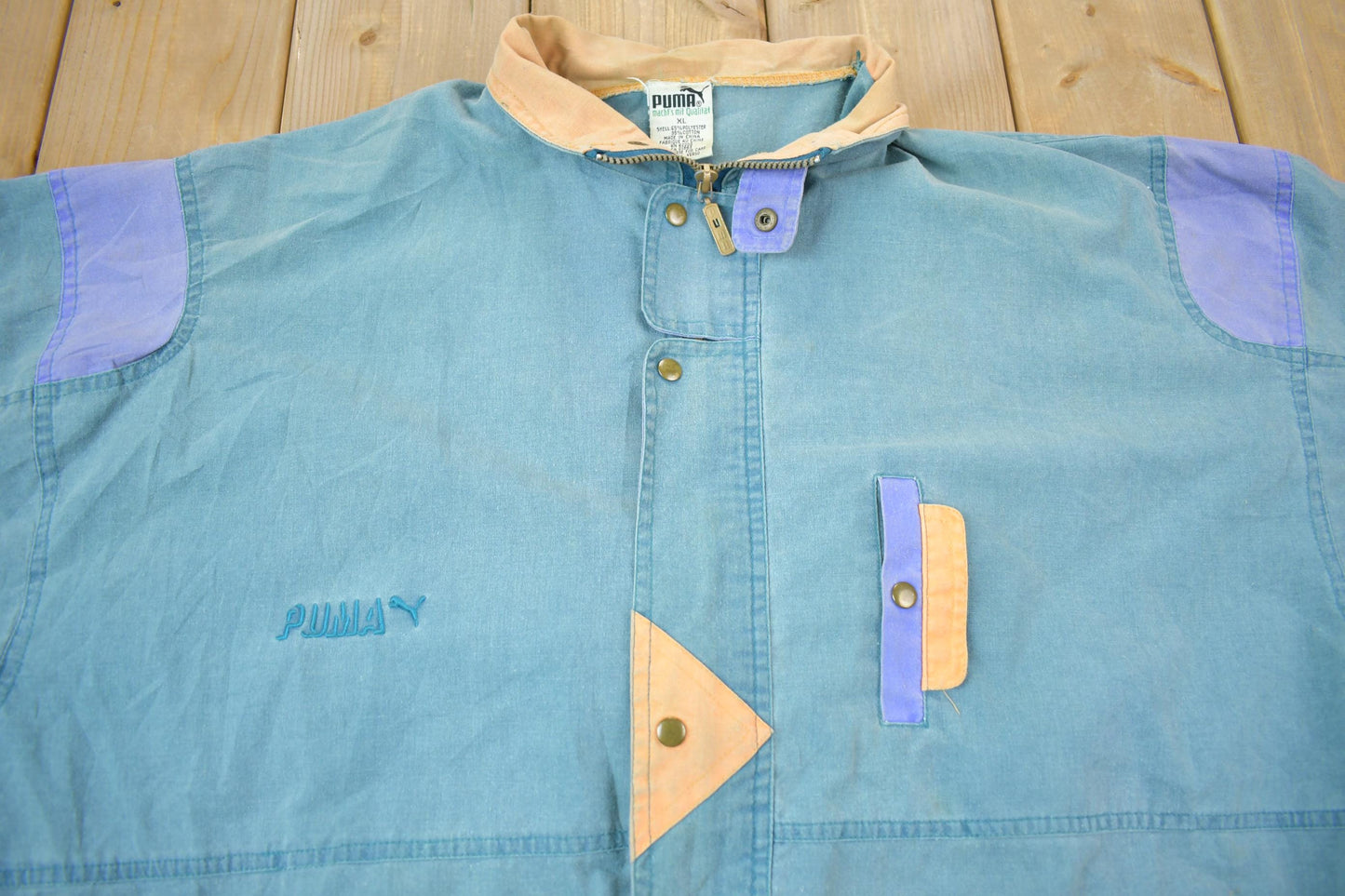 Vintage 1990s Puma Embroidered Sun Faded Windbreaker Jacket Size XL Men's XL from propervintagecanada