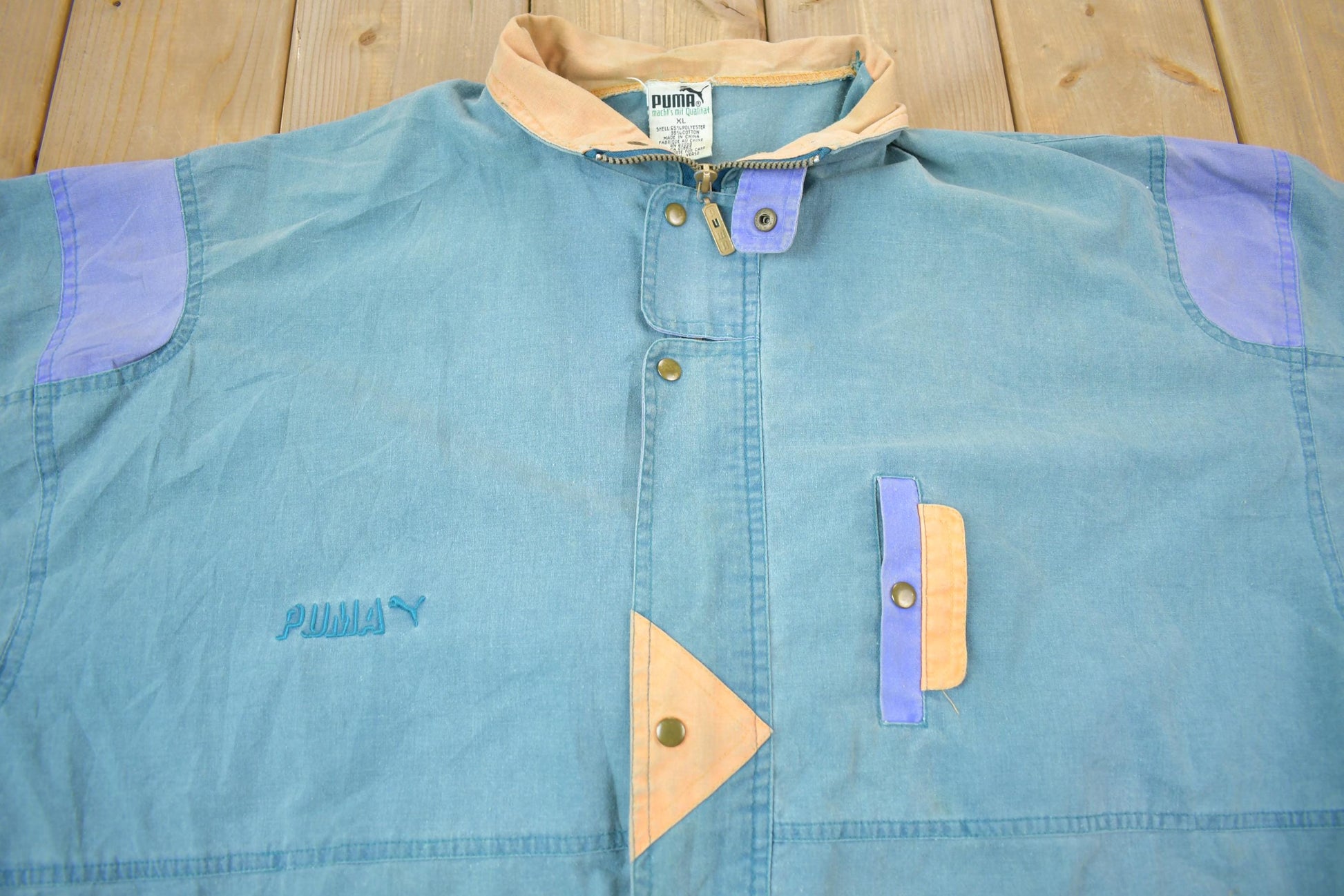 Vintage 1990s Puma Embroidered Sun Faded Windbreaker Jacket Size XL Men's XL from propervintagecanada