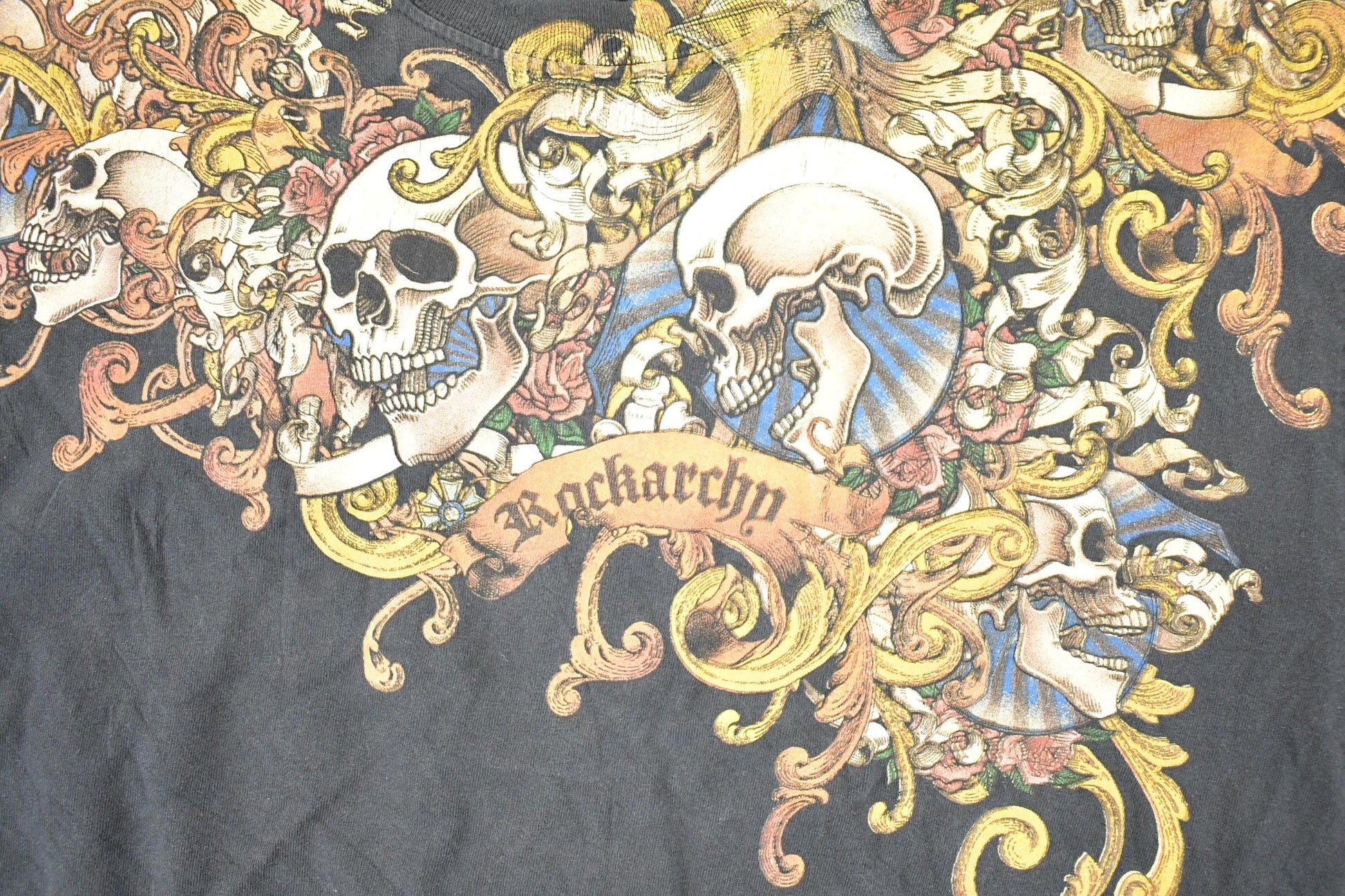 Vintage 1990s Rackarchy AOp Skulls Souvenir T-Shirt Men's L from propervintagecanada