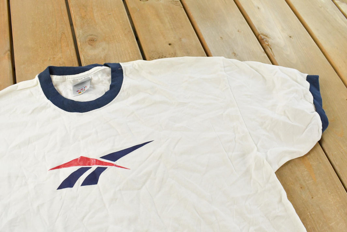Vintage 1990s Reebok Logo Ringer Graphic T Shirt Mens XL from propervintagecanada