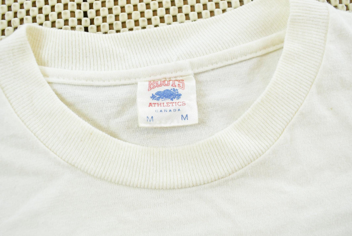 Vintage 1990s Roots Athletics Graphic T-Shirt Men's M from propervintagecanada