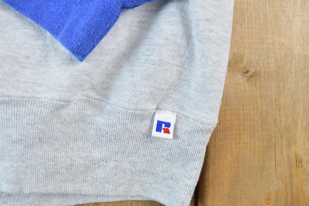 Vintage 1990s Russell Athletics Colour Block Graphic Hoodie Men's 2XL from propervintagecanada