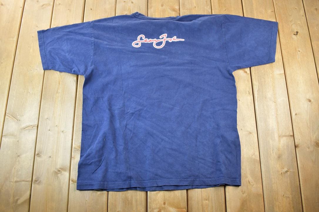 Vintage 1990s Sean John Souvenir Single Stitch Hip Hop Graphic Print T-Shirt Men's XL from propervintagecanada