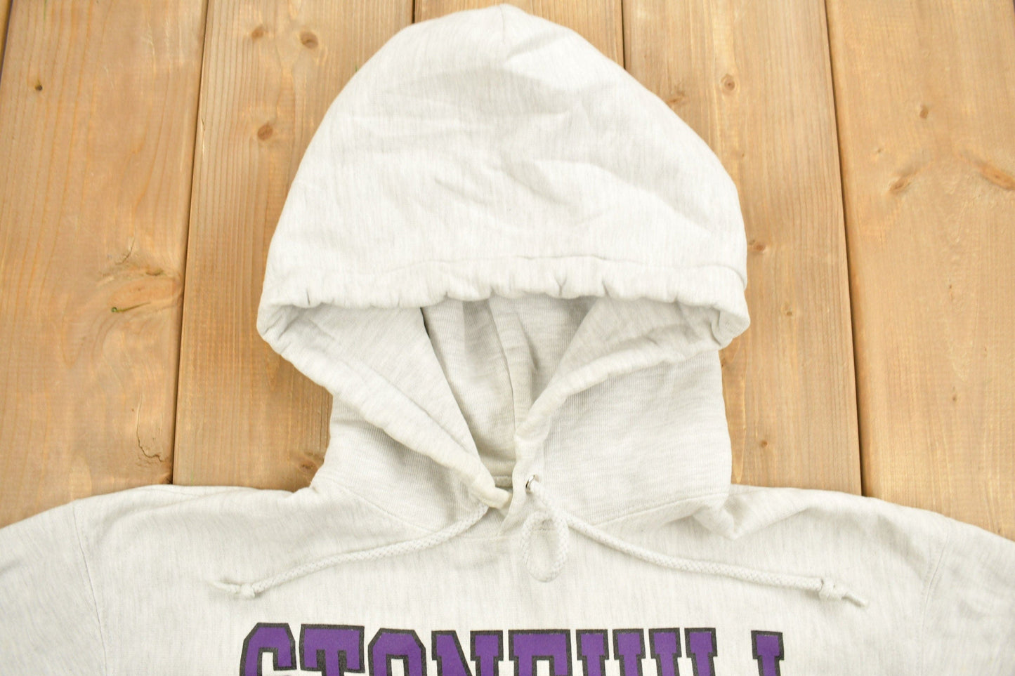 Vintage 1990s Stonehill University Collegiate Champion Reverse Weave Hoodie Men's Medium from propervintagecanada
