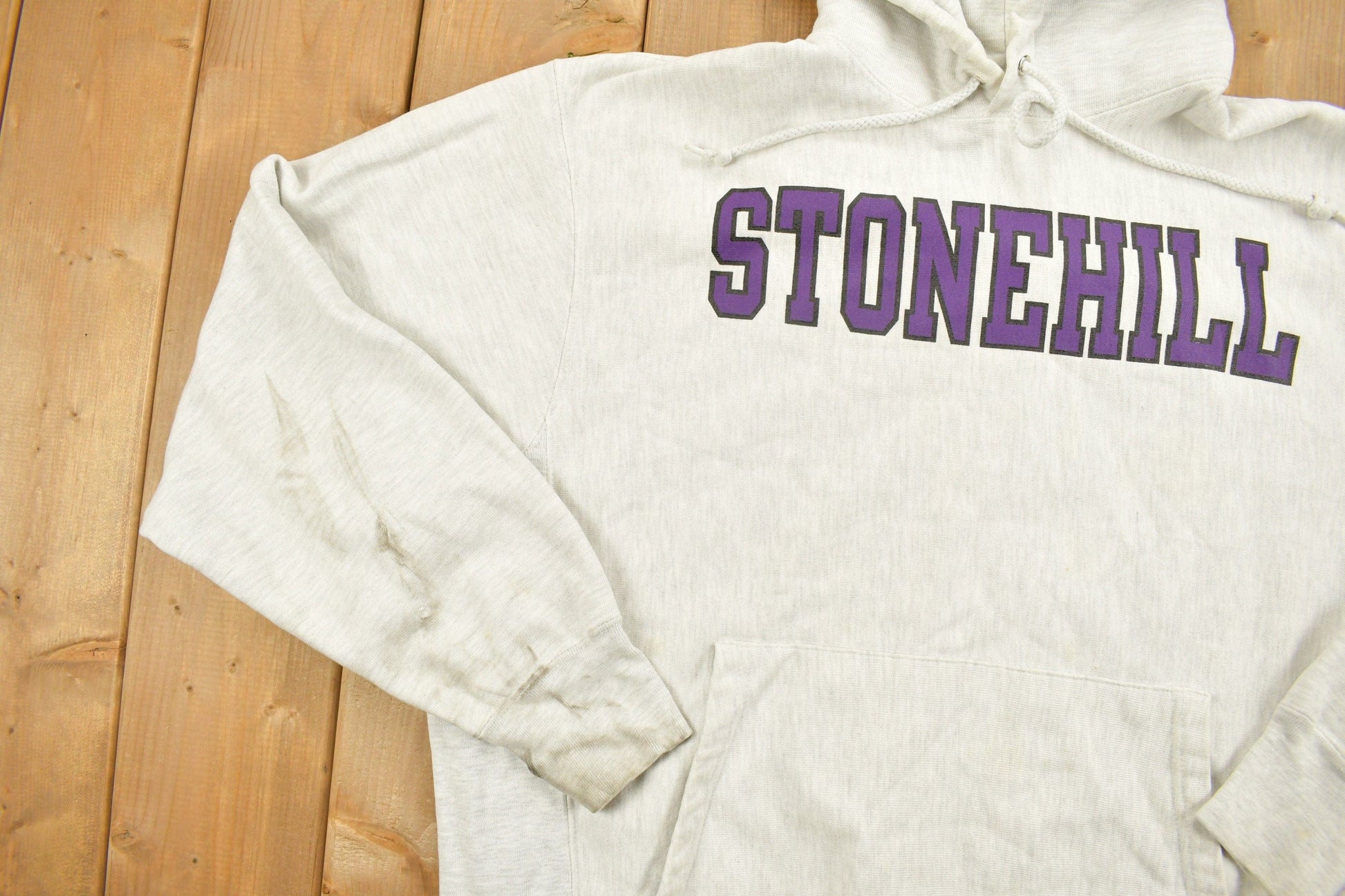 Vintage 1990s Stonehill University Collegiate Champion Reverse Weave Hoodie Men's Medium from propervintagecanada