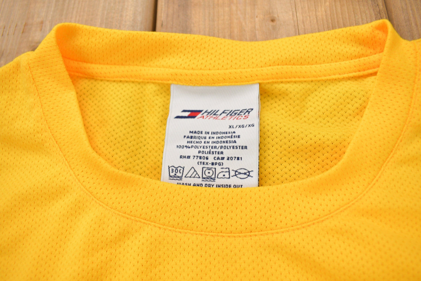 Vintage 1990s Tommy Hilfiger Athletics Graphic Jersey Style T Shirt Men's XL from propervintagecanada