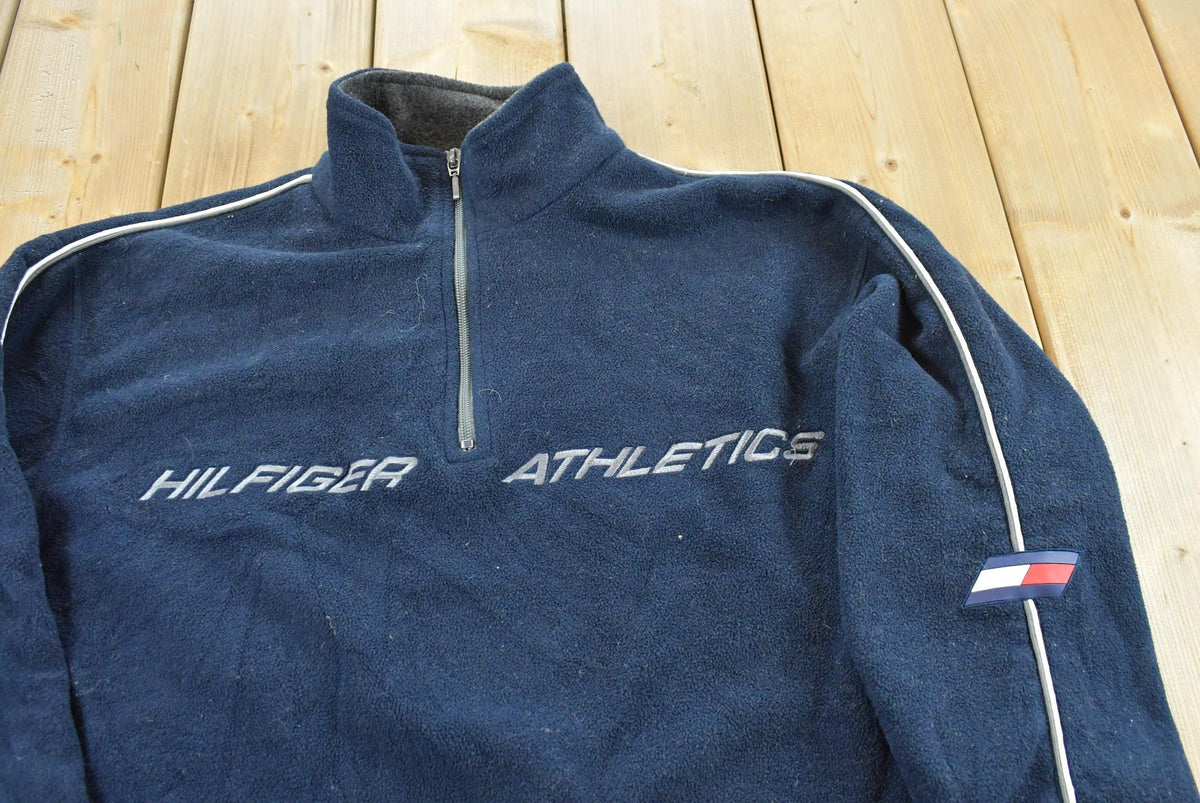 Vintage 1990s Tommy Hilfiger Athletics Spellout Quarter Zip Fleece Sweater Men's XL from propervintagecanada