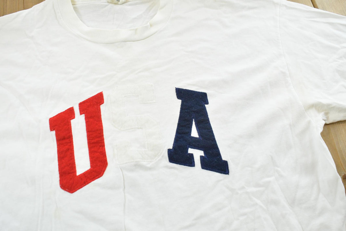Vintage 1990s USA Embroidered Lettering Red White Blue T-Shirt Mens L from propervintagecanada