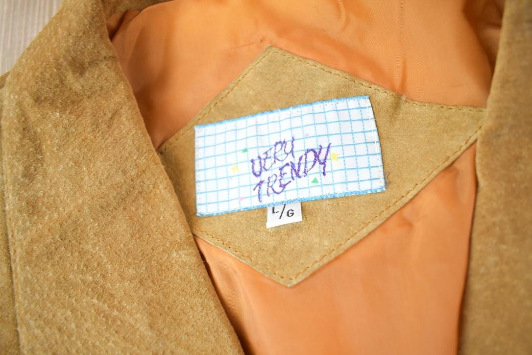 Vintage 1990s Very Trendy Brown Suede Leather Fringe Jacket Women's L from propervintagecanada