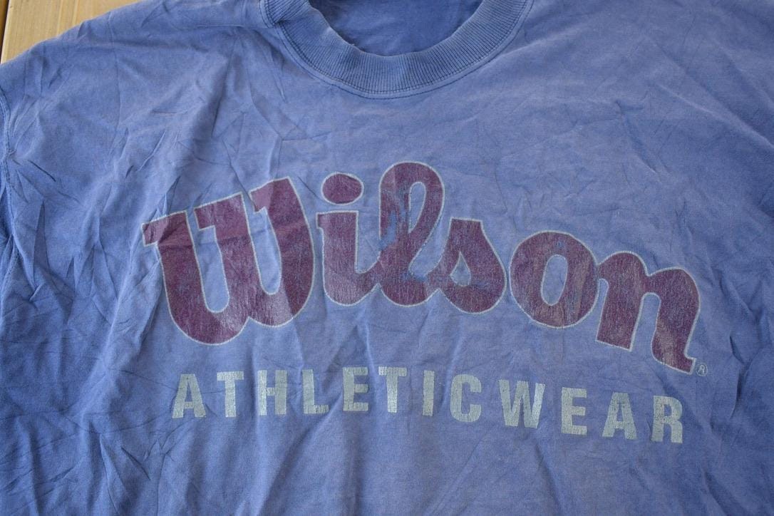 Vintage 1990s Wilson Souvenir Single Stitch Graphic Print T-Shirt Men's 2XL from propervintagecanada
