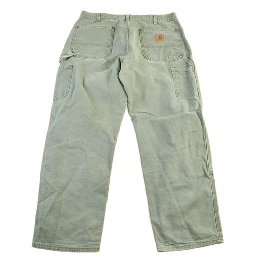 Vintage 2000s Carhartt Distressed Double Knee Denim Work Jeans Men's Large 35 x 29 from propervintagecanada