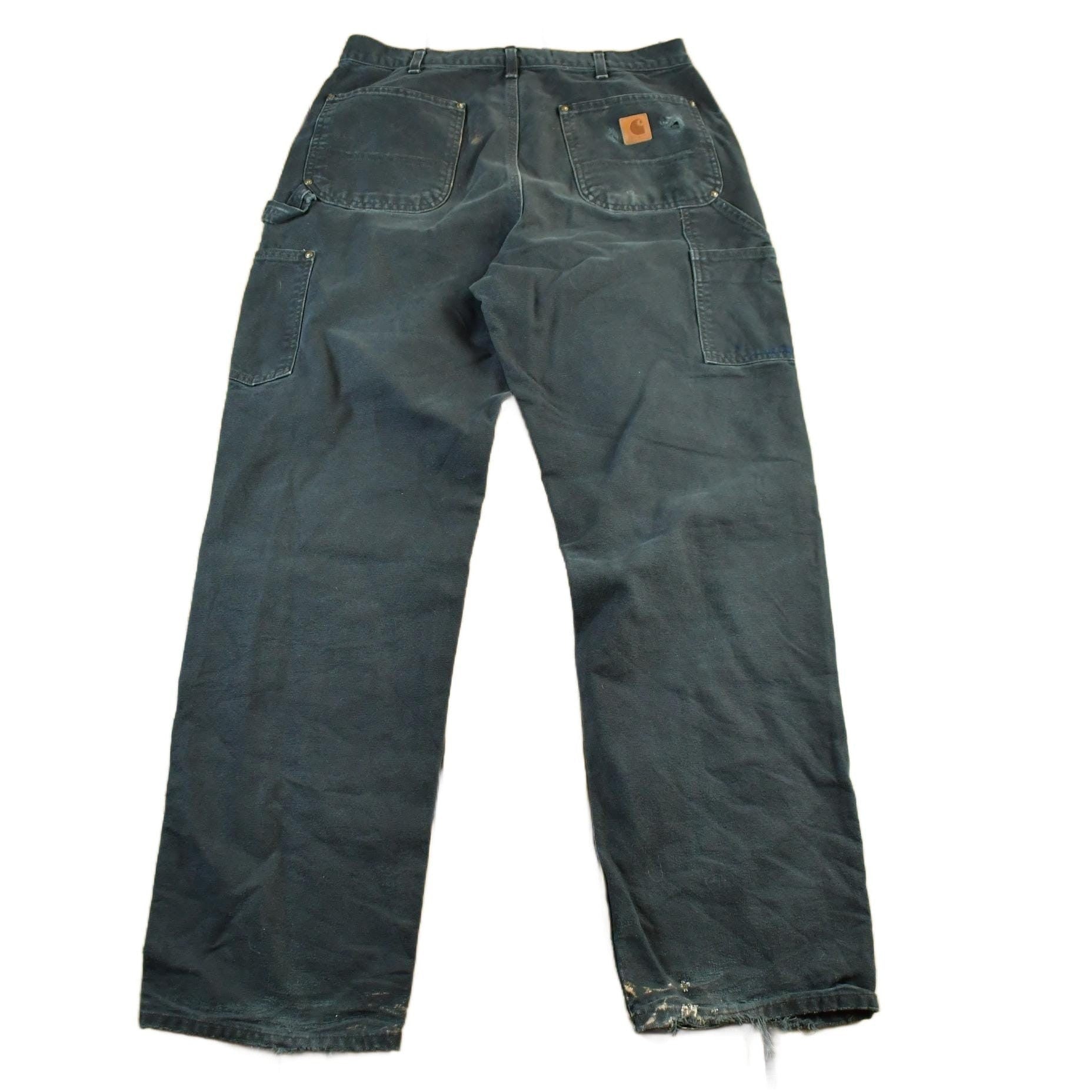 Vintage 2000s Carhartt Distressed Double Knee Denim Work Jeans Men's Medium 33 x 32 from propervintagecanada